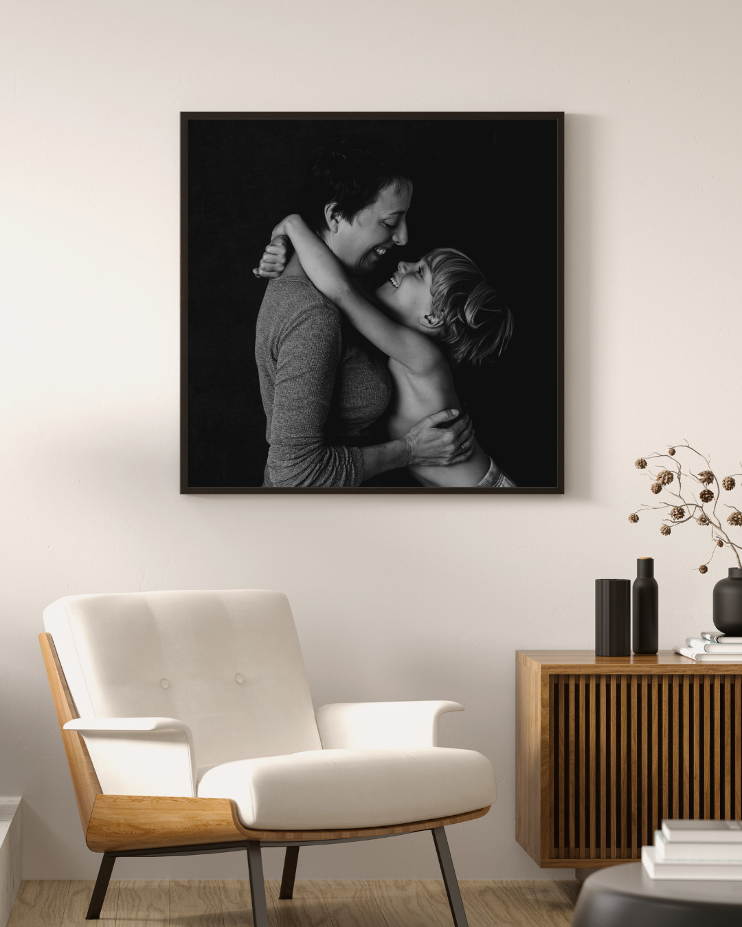 Black and white family portrait of a mother and son displayed as wall art in a mid-century modern living room