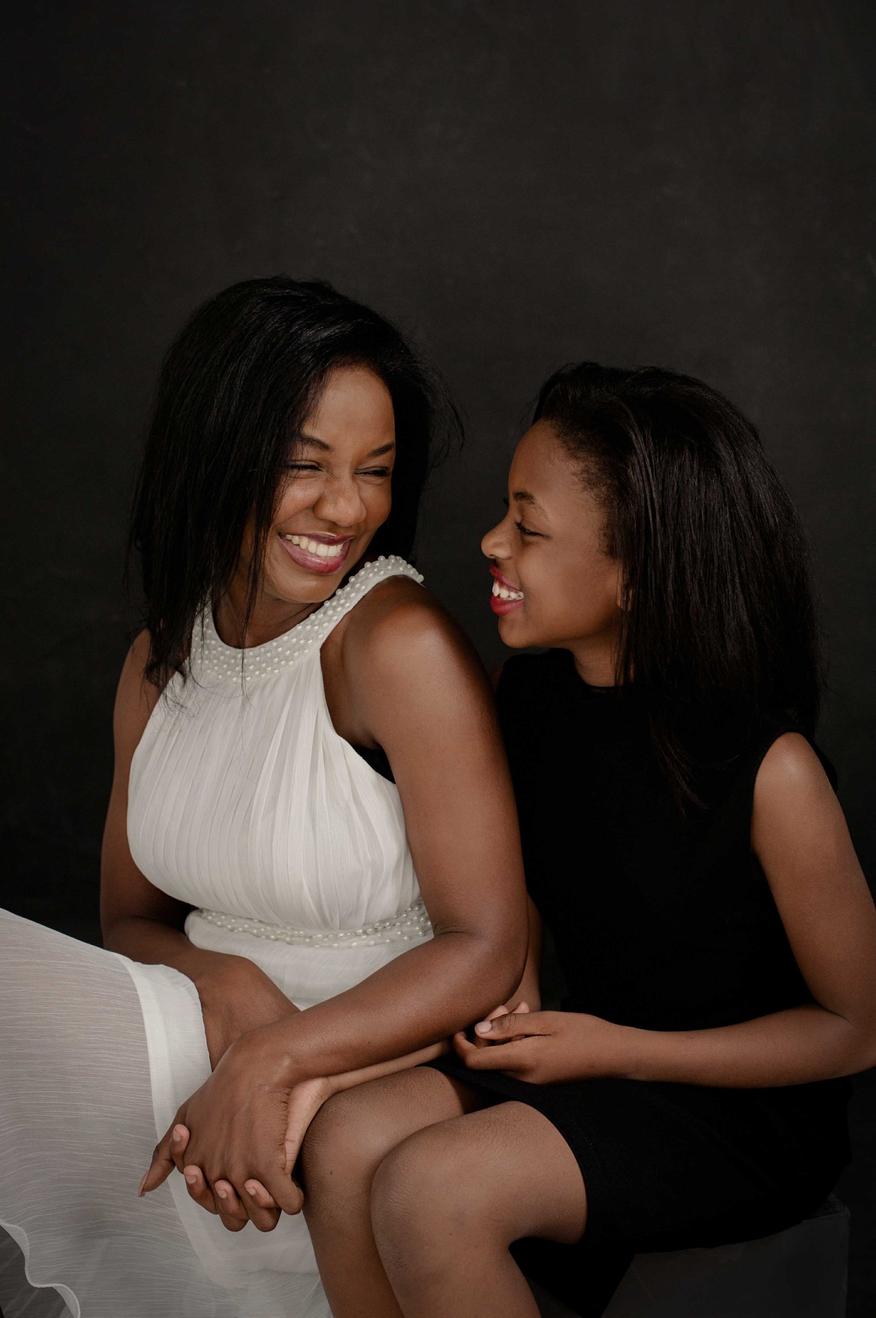 A mother and daughter sharing a joyful laugh.