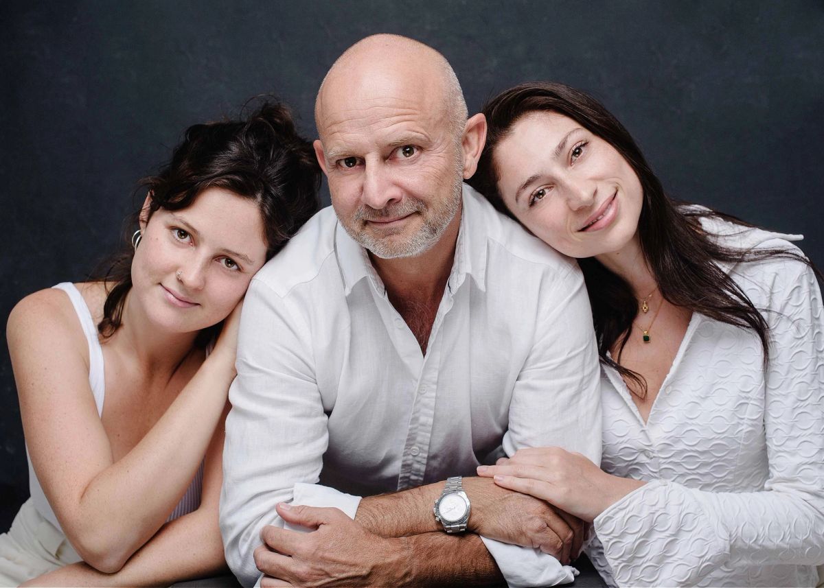 Parents and children resting their heads together.